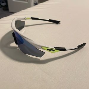 Oakley M-Frame sunglasses. Black, white, neon green accent.